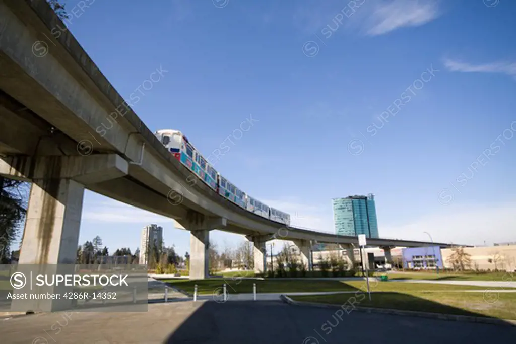 Skytrain passes overhead, Holland Park, Surrey Central, BC, Canada