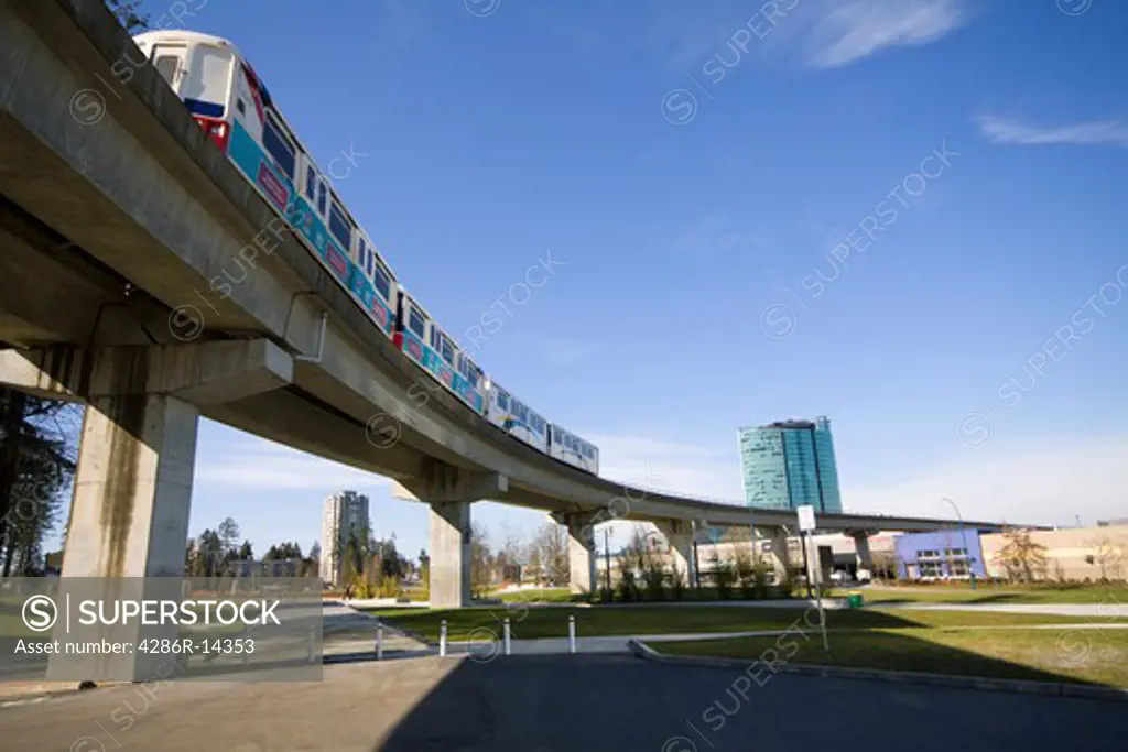 Skytrain passes overhead, Holland Park, Surrey Central, BC, Canada. Skytrain is a fully automated rapid transit system built by Bombardier.