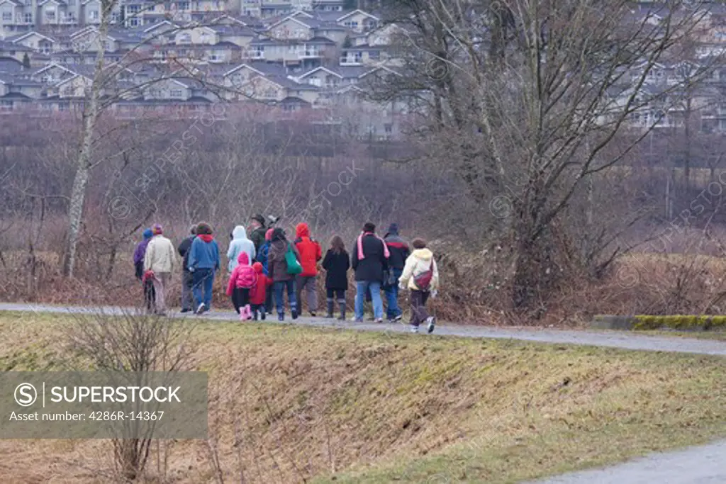 Group of bird watchers going out with a guide at Colony Farm, Port Coquitlam, BC, Canada