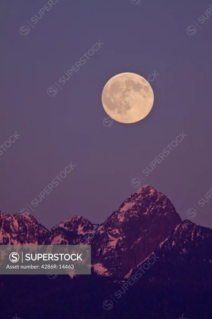 Full moon rises over Mount Blanshard, from Port Coquitlam, BC, Canada.