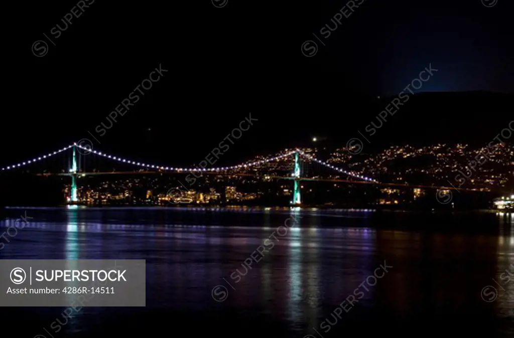Lions Gate Bridge at night reflected in the harbour Vancouver, BC, Canada