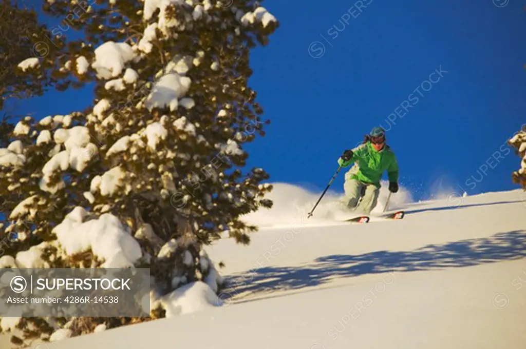 A young woman skiing powder snow in Lake Tahoe, CA.