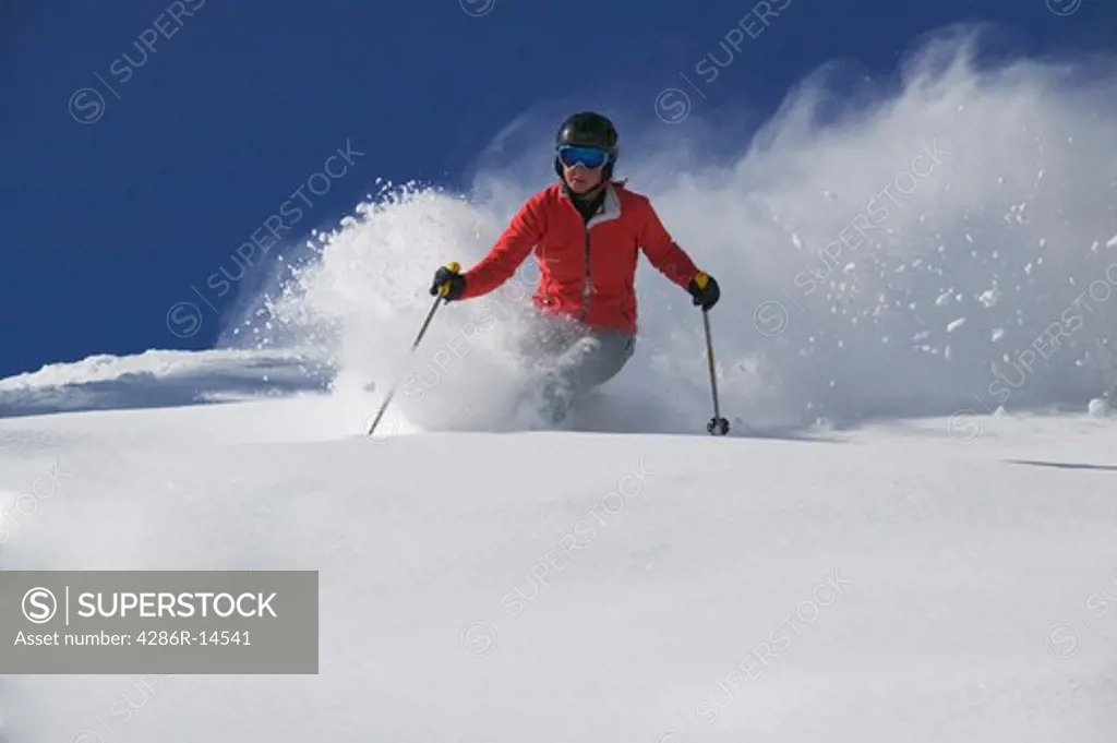 A young woman skiing powder snow in Lake Tahoe, CA.