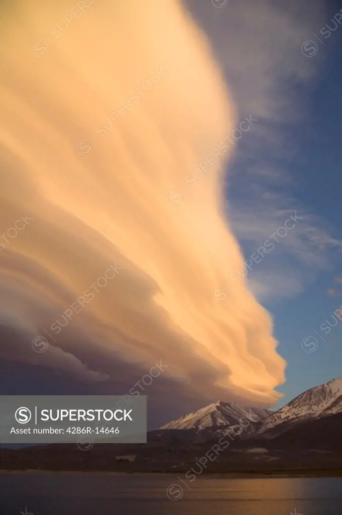 A lenticular cloud at sunset over Crowley Lake, CA and the Sierra mountains.