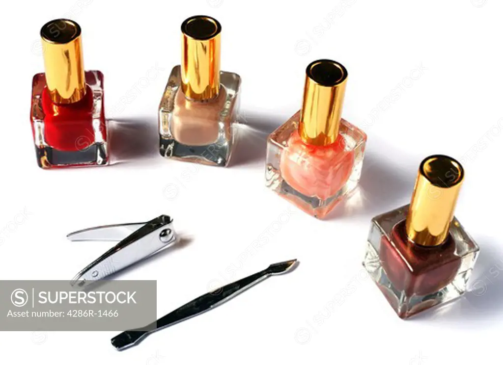 Different coloured nail varnishes, nail clippers and cuticle stick.