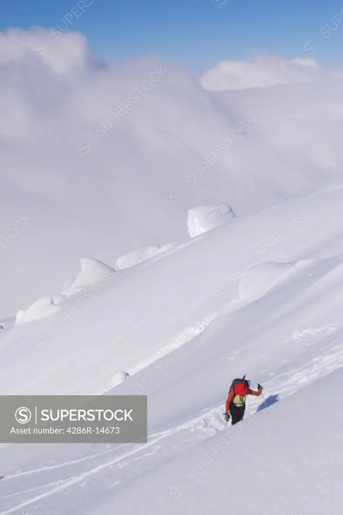 A woman ski mountaineering on Mount Vsevidov in the Aleutian Islands, Alaska
