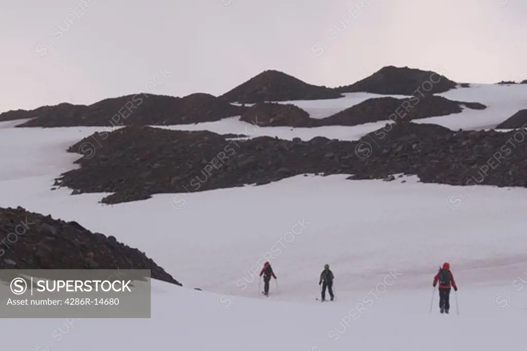 Three skiers climbing Mount Vsevidov in the Aleutian islands.