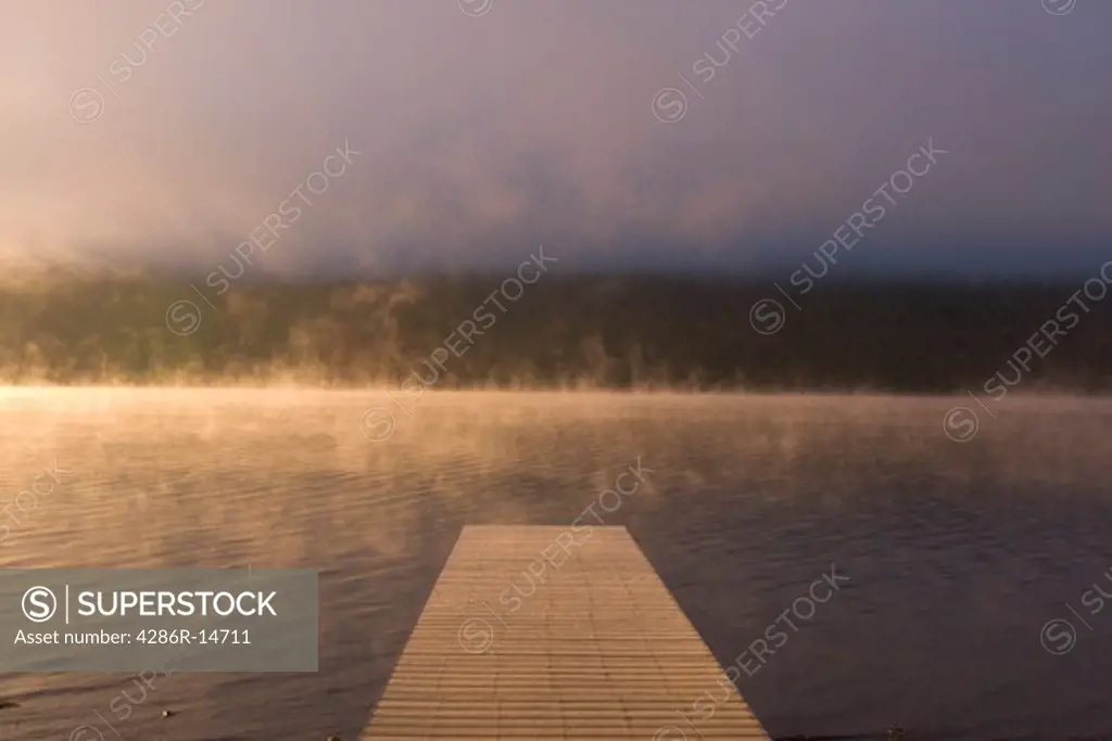 Mist rising from Doner Lake , California at Sunrise.
