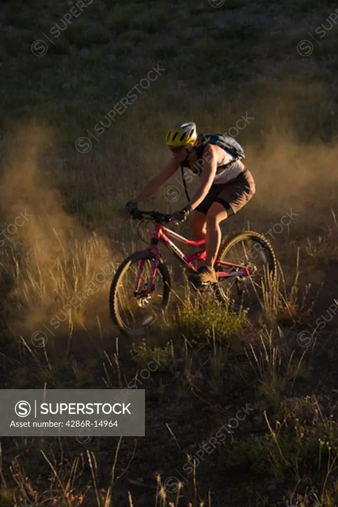 A man mountain biking in the dust in the Sierra mountains of California