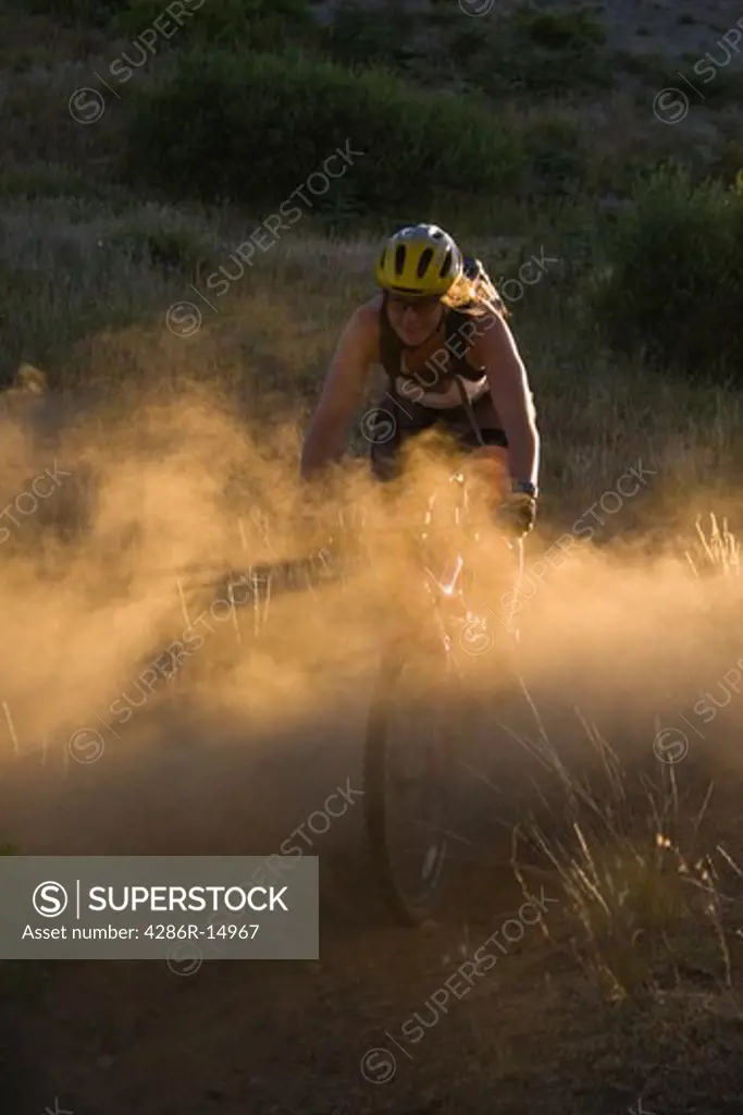 A man mountain biking in the dust in the Sierra mountains of California