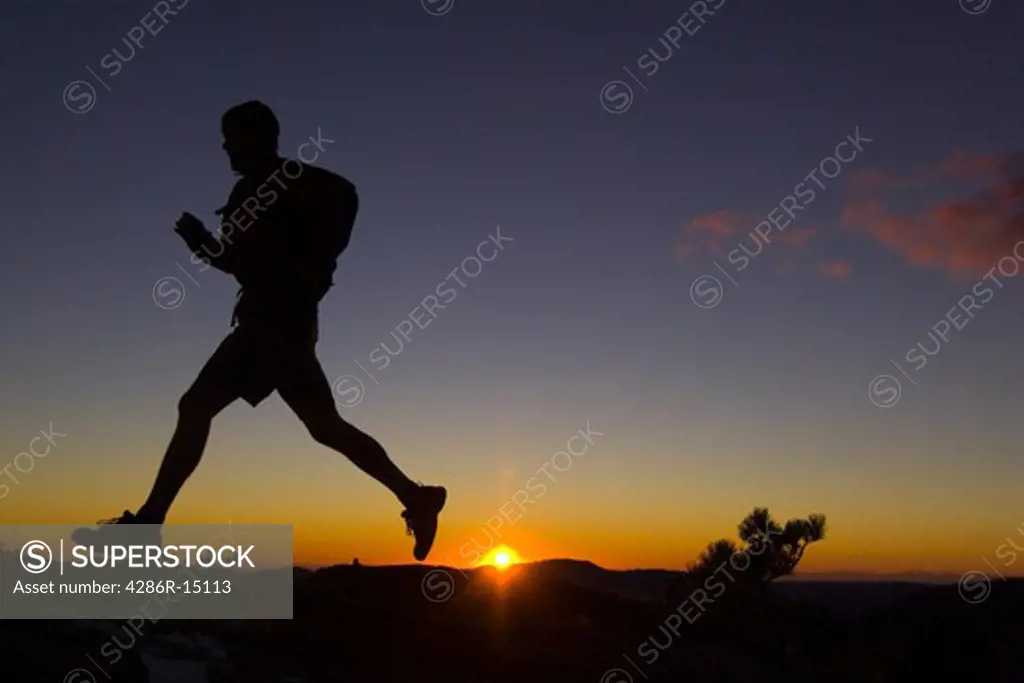A man trail running at sunset in the mountains above Lake Tahoe California