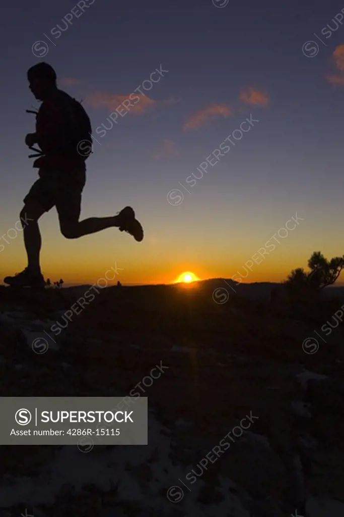 A man trail running at sunset in the mountains above Lake Tahoe California