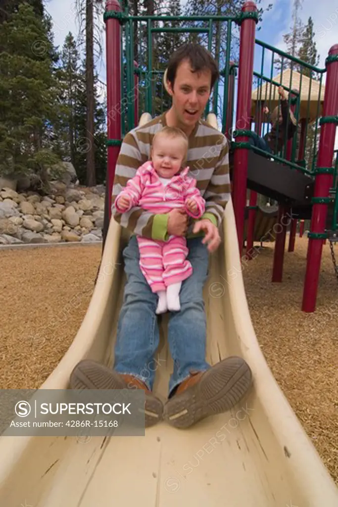 A father and child playing in a playground near Squaw Valley California