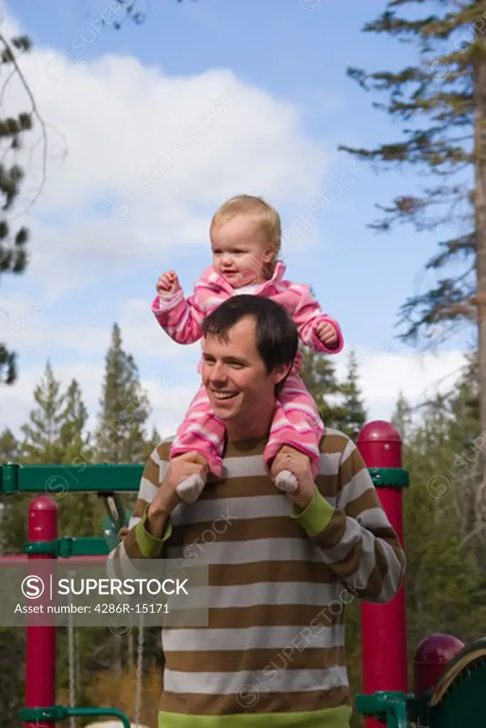 A father and child playing in a playground near Squaw Valley California