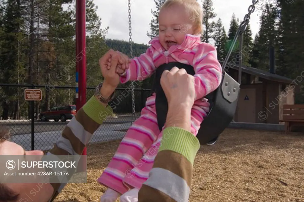 A father and child swinging in a playground near Squaw Valley California