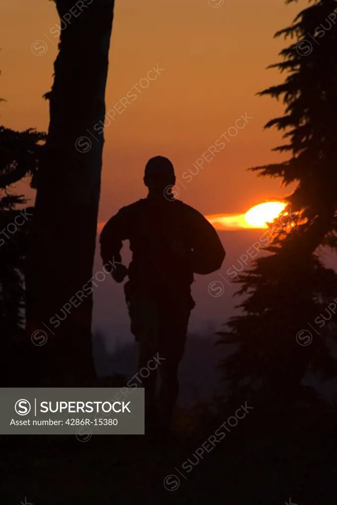 A man running at sunset on the Tahoe Rim Trail above Lake Tahoe California