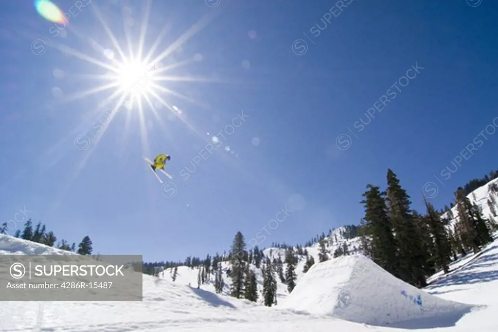 A skier jumping off a huge jump at Alpine Meadows in California