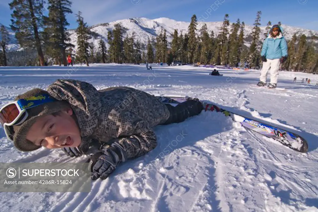 A boy falling while skiing at Sierra at Tahoe ski resort near Lake Tahoe in California