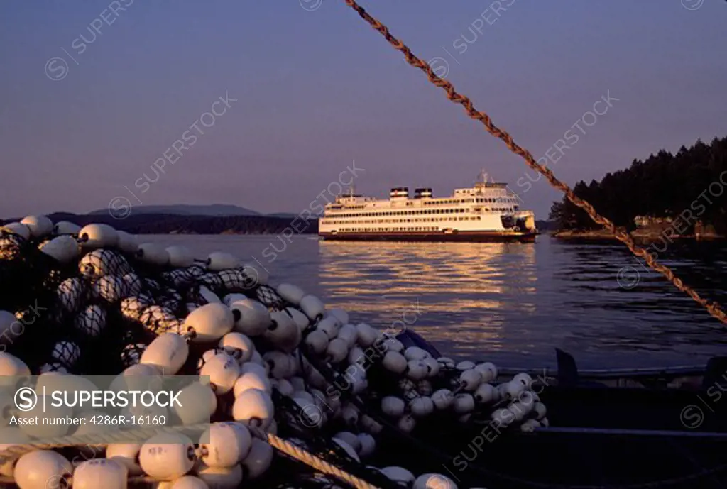 A ferry from the Washington State ferry system and fishing nets at sunset in Friday Harbor in the San Juan Islands Washington