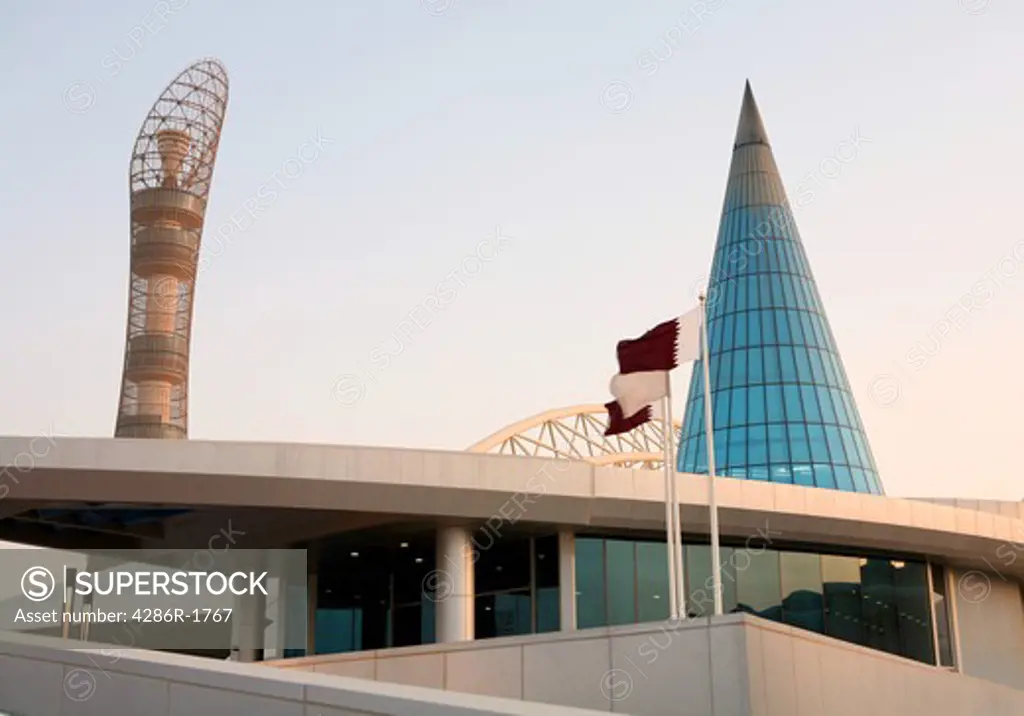 The Aspire sports academy in Doha, Qatar, with the Qatari flag flying and the 2006 Asian Games torch tower in the background.