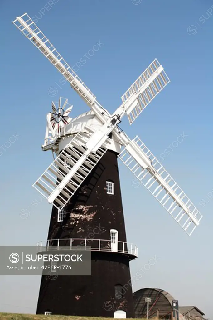 The restored waterpump Berney Arms Mill on Halvergate Marsh in the Norfolk Broads' parish of Reedham, England. The mill was built in 1865 to grind cement clinker and was later converted into a drainage windpump. It is Norfolk's tallest mill, at 70ft 6ins excluding the sails.