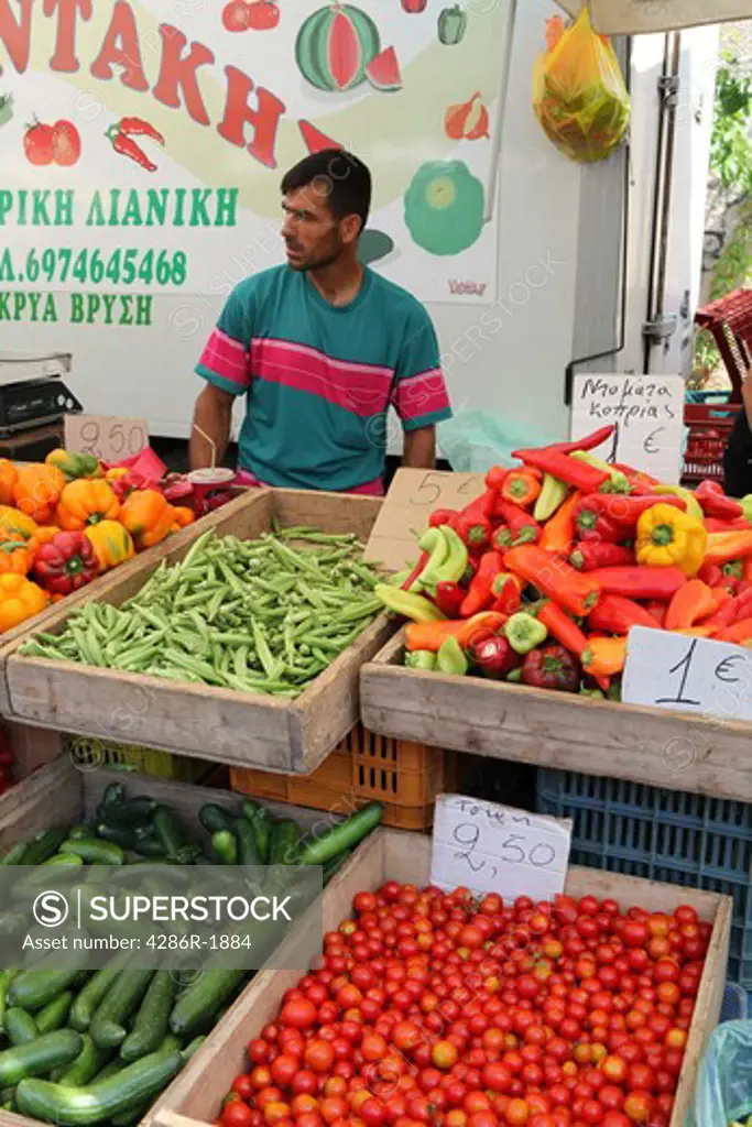 A market stall in rethymnon, Crete, Greece, with the farmer selling his vegetables. Focus on the produce.