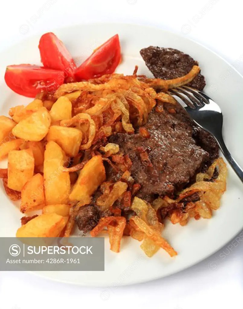 Traditional Austrian zweibelrostbraten, beef escalope with crispy fried onions, served with diced deep fried potatoes. The easily made meal is popular in Central European countries including Austria and Hungary.
