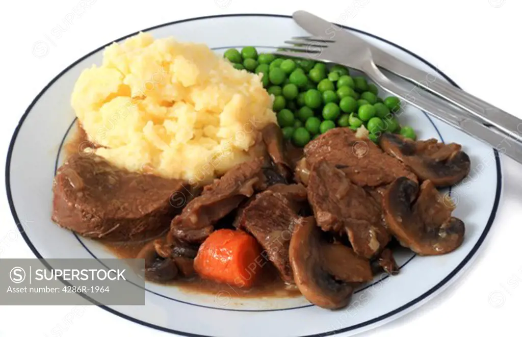 A plate of beef and mushroom stew, served with boiled mashed potatoes and boiled peas