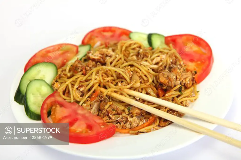 A meal of chinese chicken chilli and garlic noodles,  with bamboo chopsticks