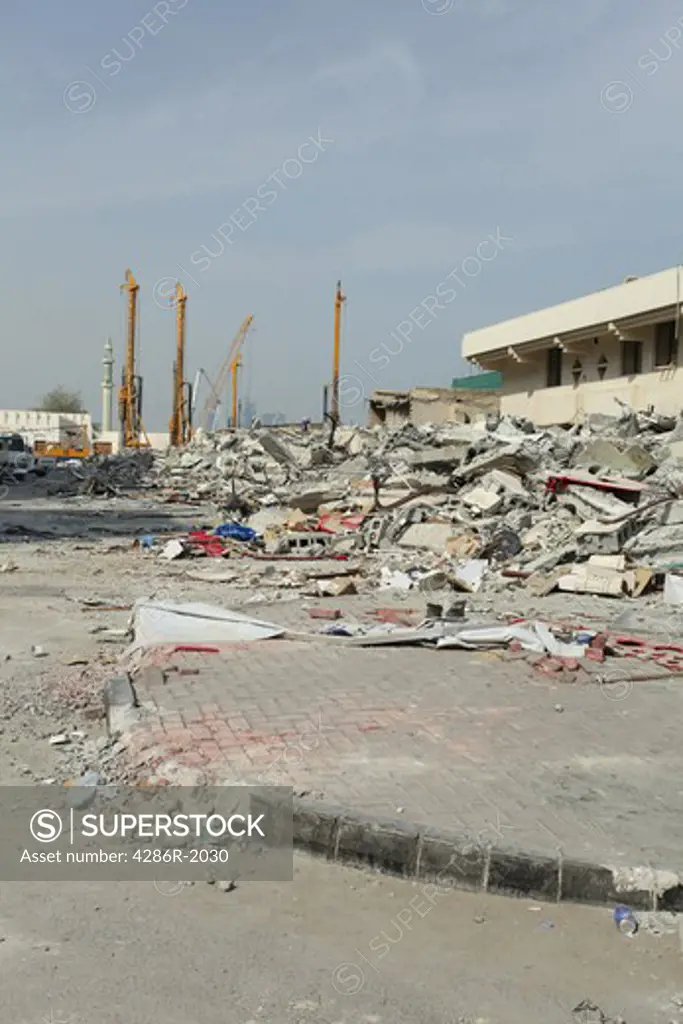 The destruction of the old city centre in Doha, Qatar, to make way for a massive redevelopment project. October 2009. The minaret of the state's Grand Mosque, next to the Emiri Diwan palace, is visible in the background.