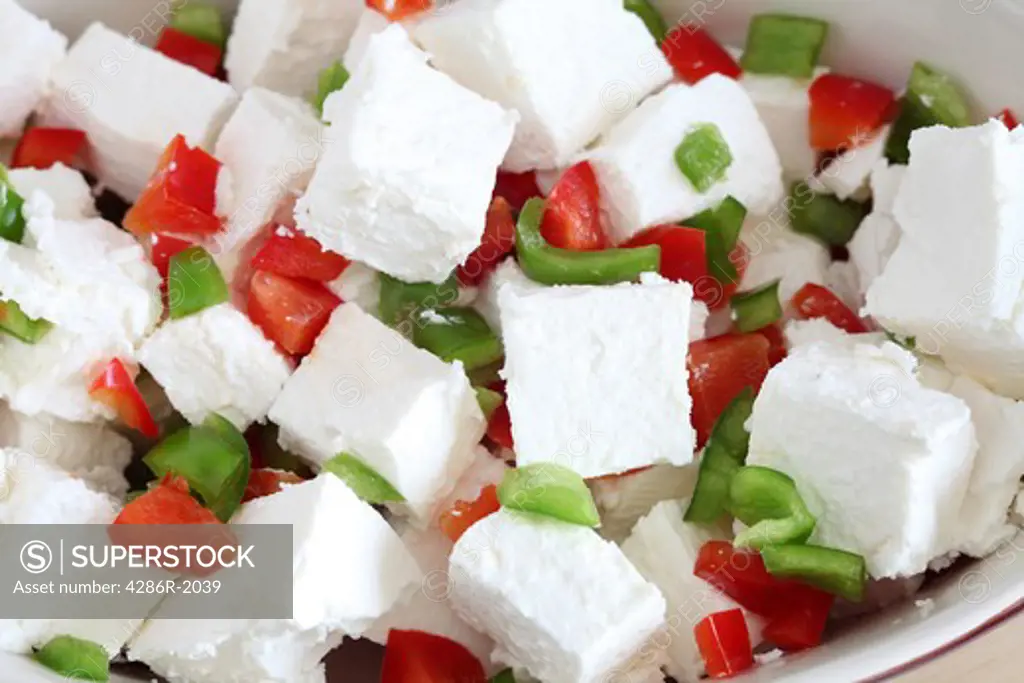 A tasty and eye-catching salad of feta cheese and diced red and green capsicums