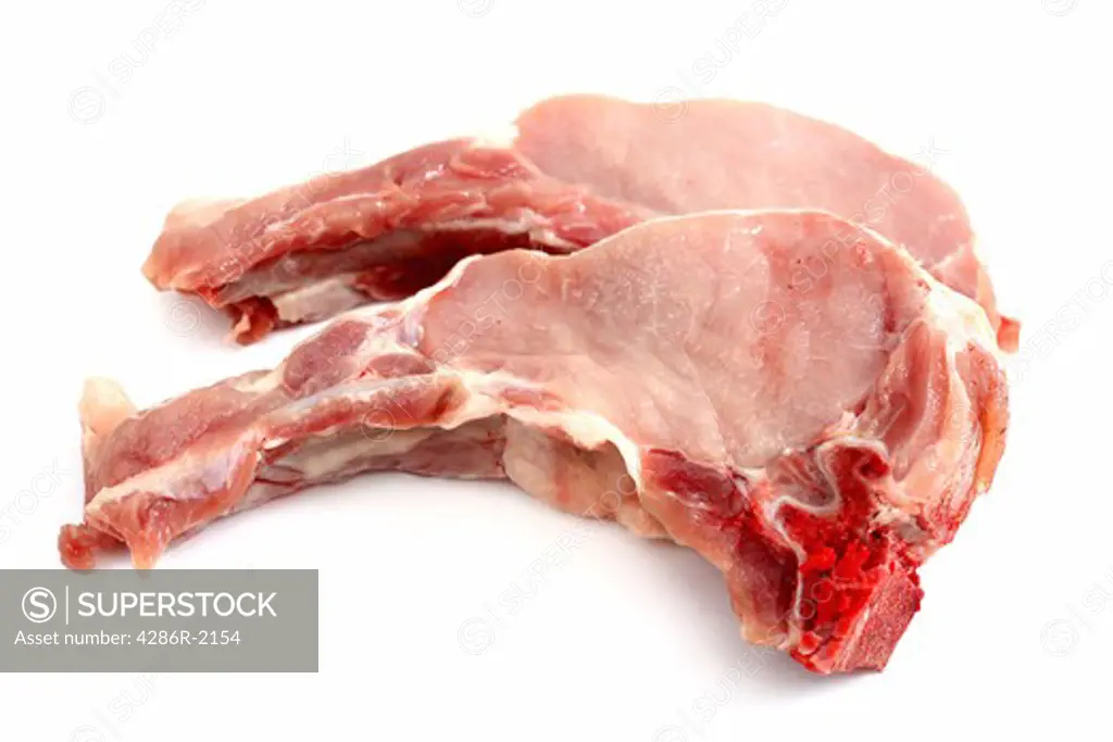 Two raw pork loin chops with shadow on a white background