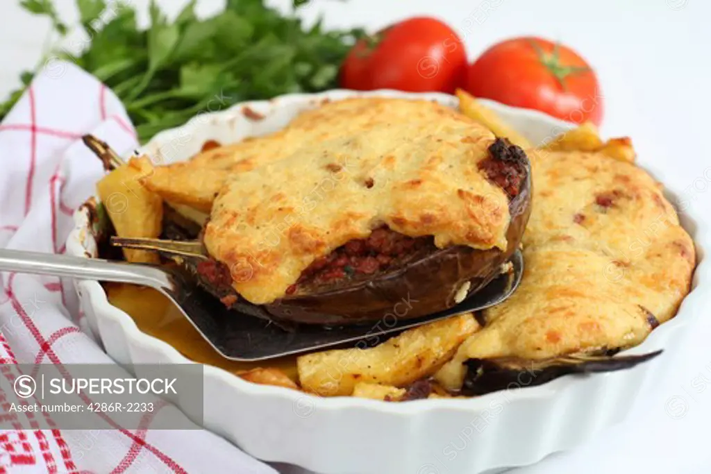 Traditional Greek 'papoutsakia', eggplants stuffed with a minced beef, parsley and tomato sauce, topped with bechamel sauce and baked in the over. The dish is delicious and is a great favourite with the Greeks.