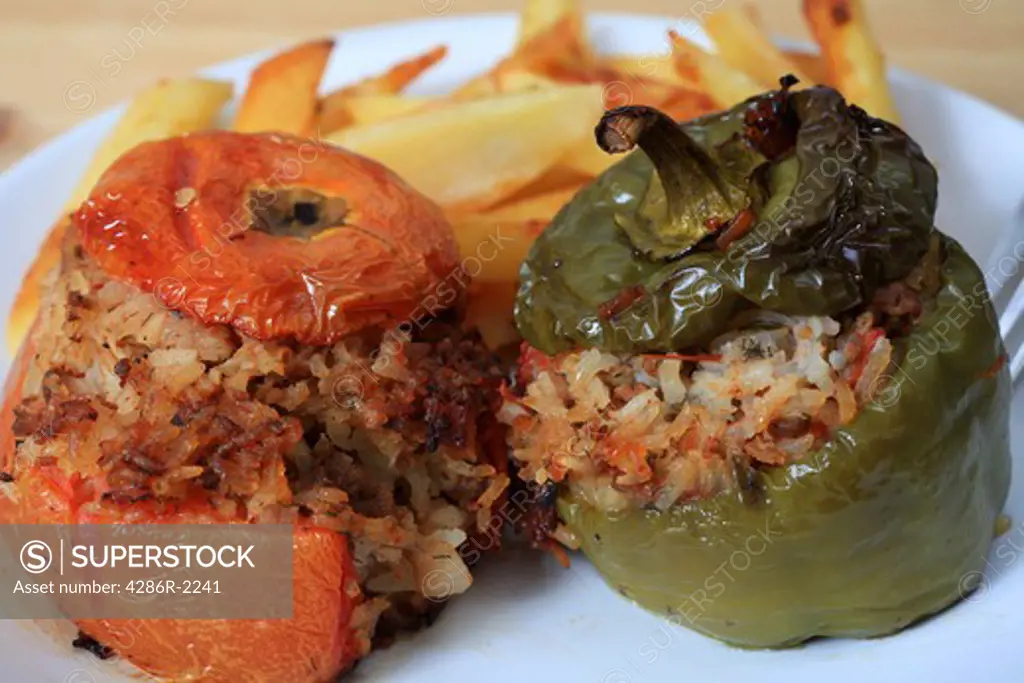Stuffed vegetables in the Greek style filled with meat and rice and served with french fried potato chips