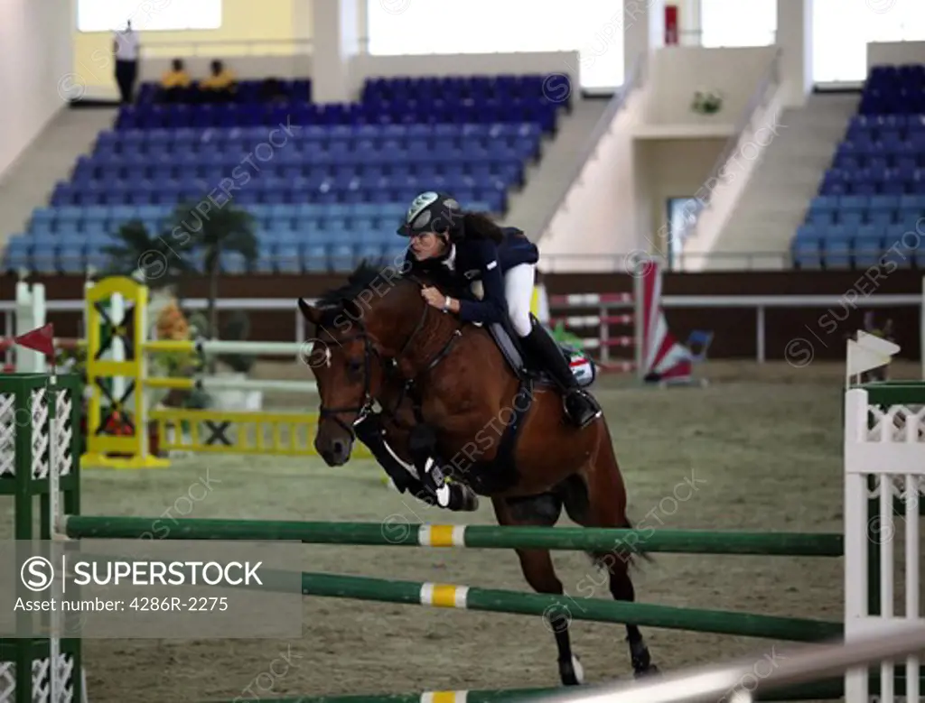 A Kuwaiti woman showjumper in action at a regional competition held at the Qatar Equestrian Federation's indoor arena in Doha, November 2009