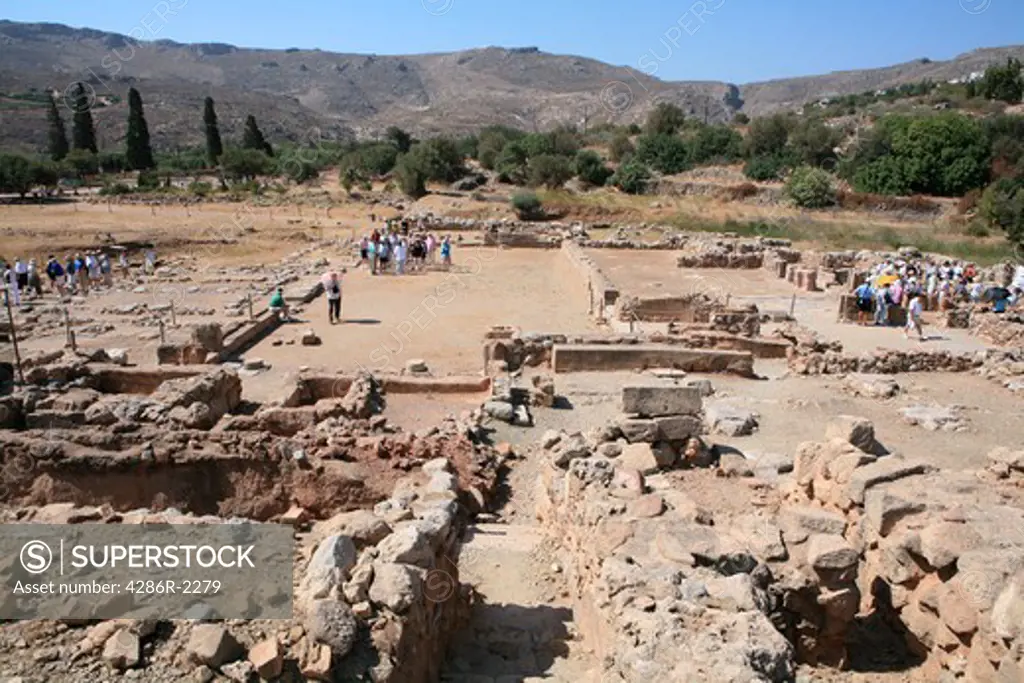Groups of tourists visit the ruins of the ancient Minoan palace complex at Zakros, eastern Crete.