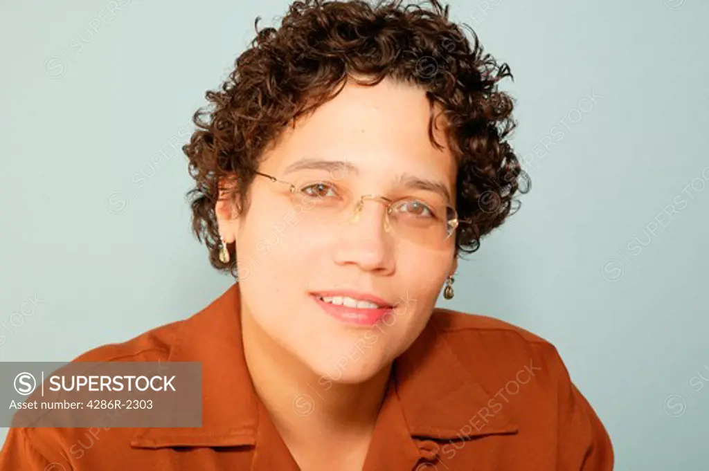 Studio shot of an African-American woman wearing glasses.