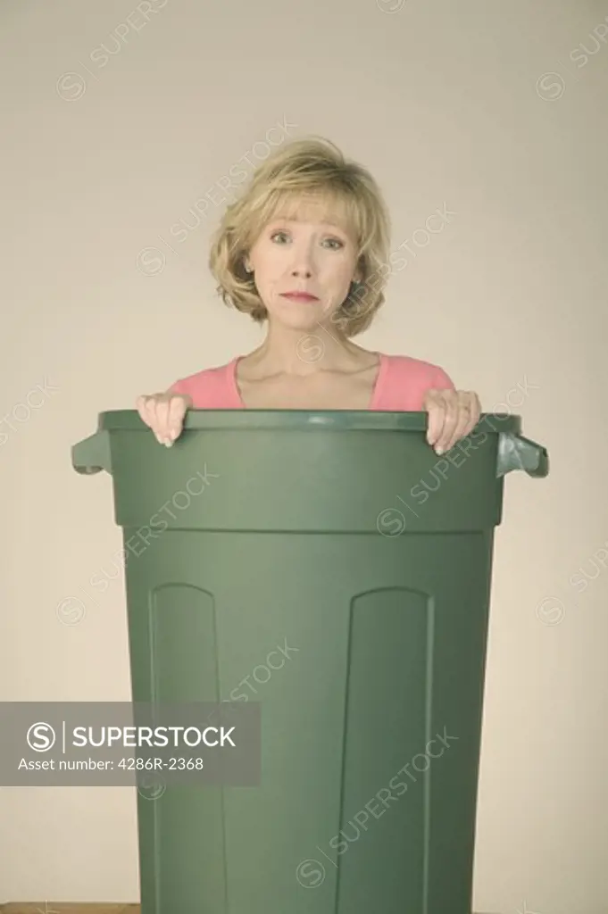 Woman with her green trash can