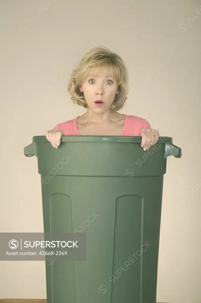 Woman with her green trash can