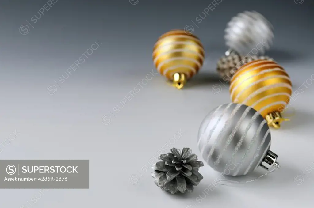Christmas background with glass bauble ornaments and pine cones