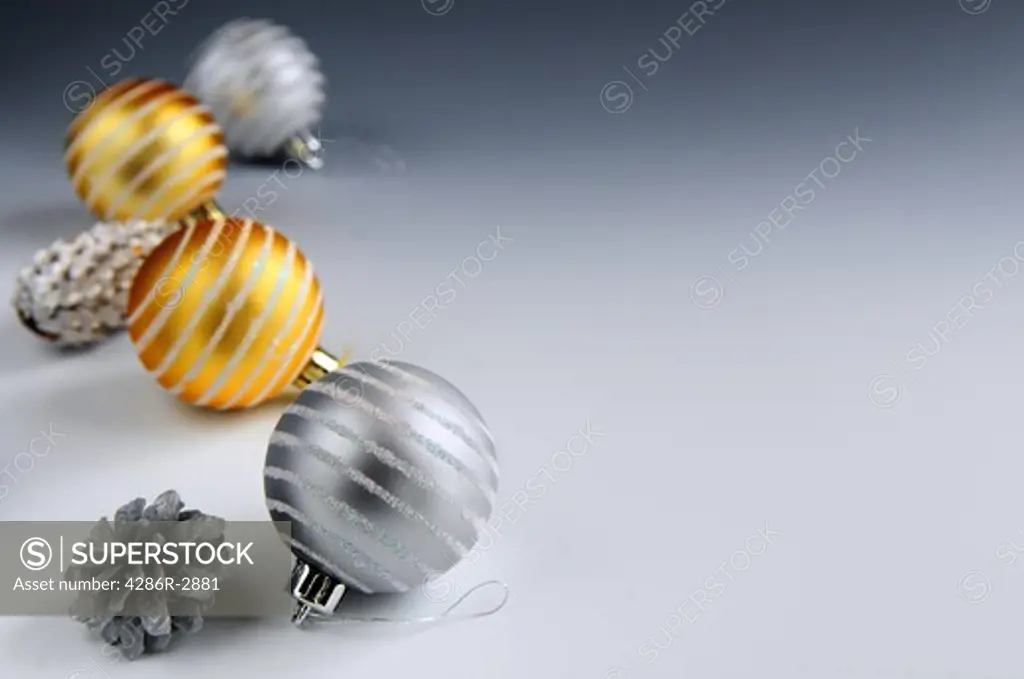 Christmas arrangement with glass bauble ornaments and pine cones, background