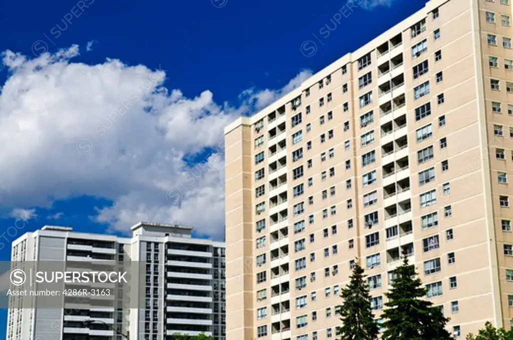 Tall residential apartment buildings with blue sky