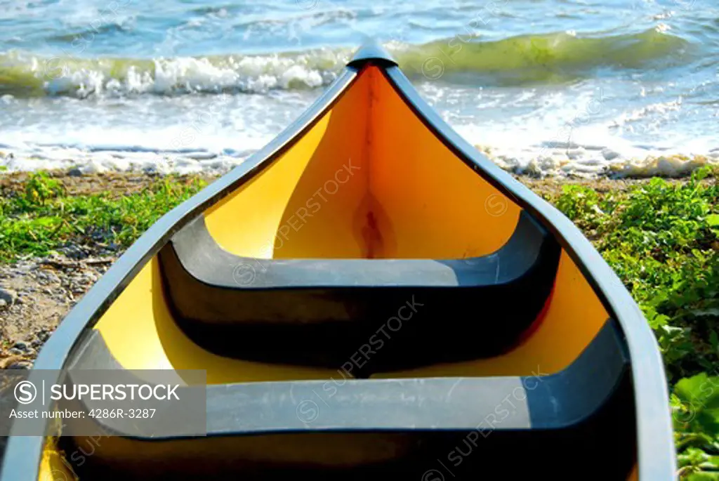 Yellow canoe on lake shore