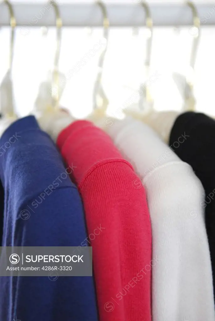 Closeup of womens clothes hanging in a closet