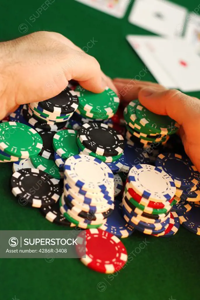 Poker player raking a big pile of chips