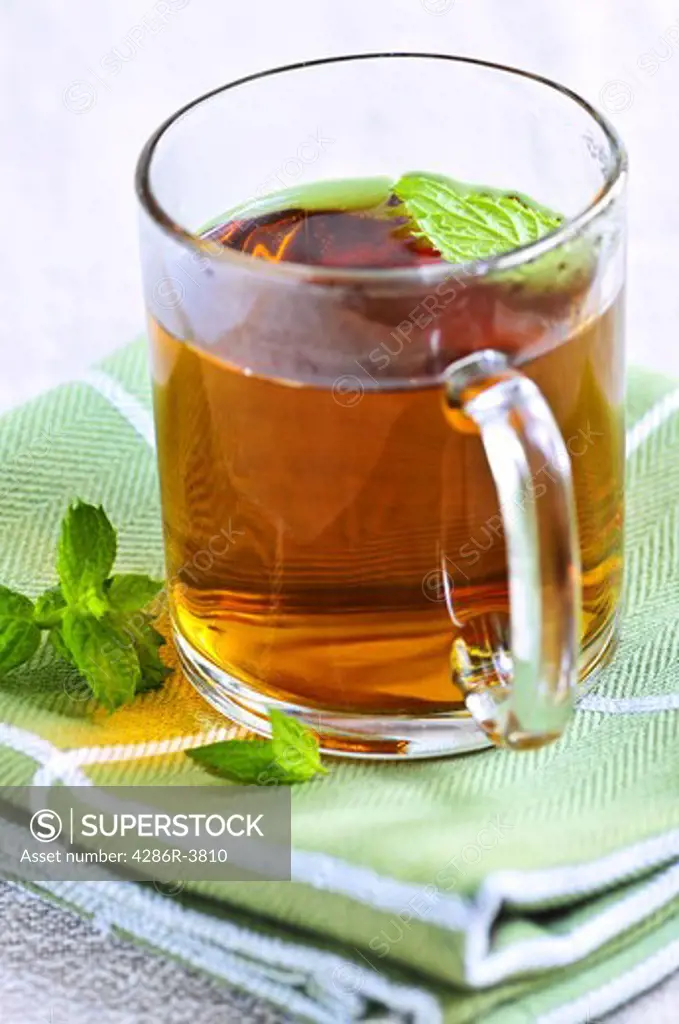 Cup of fresh herbal mint tea with peppermint leaves