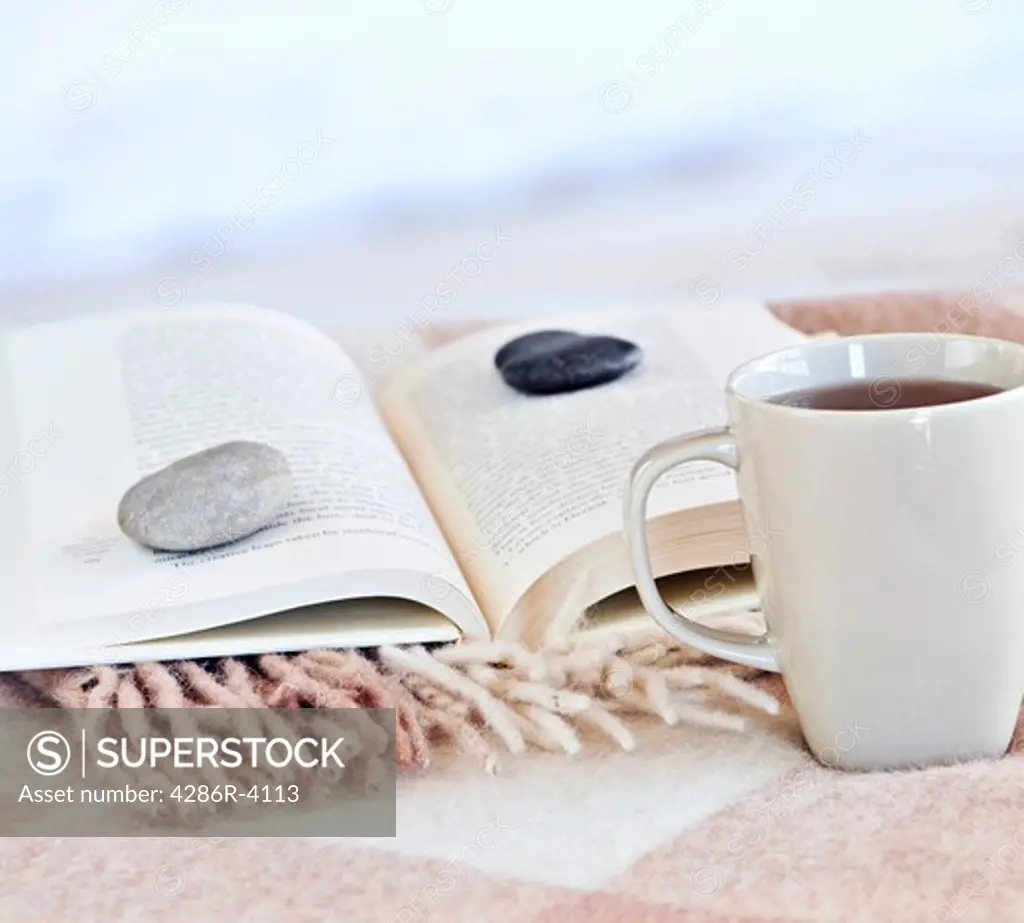 Relaxing with a book and cup of tea at the beach