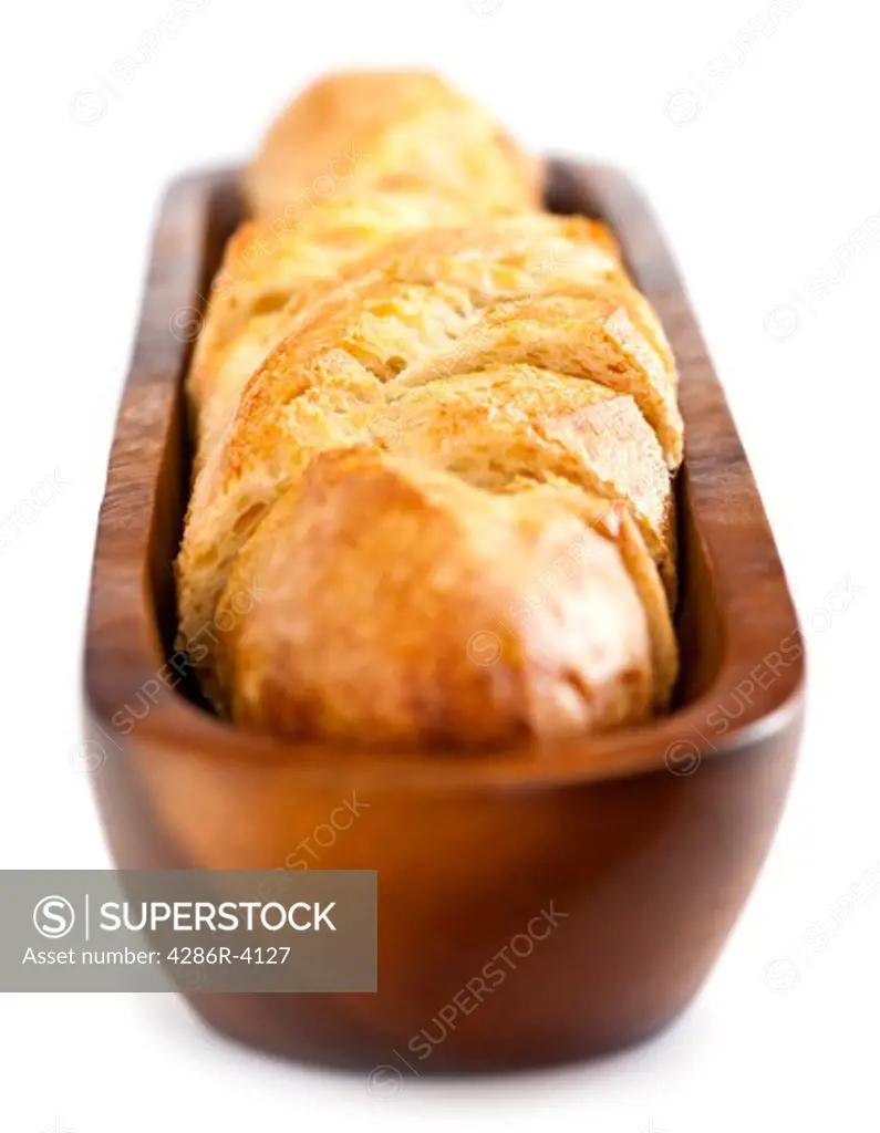 Isolated sliced baguette bread in wooden dish