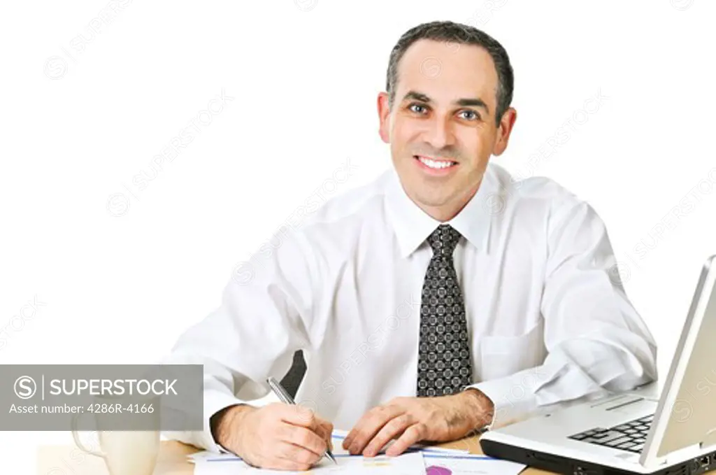 Happy office worker reviewing generic reports at his desk