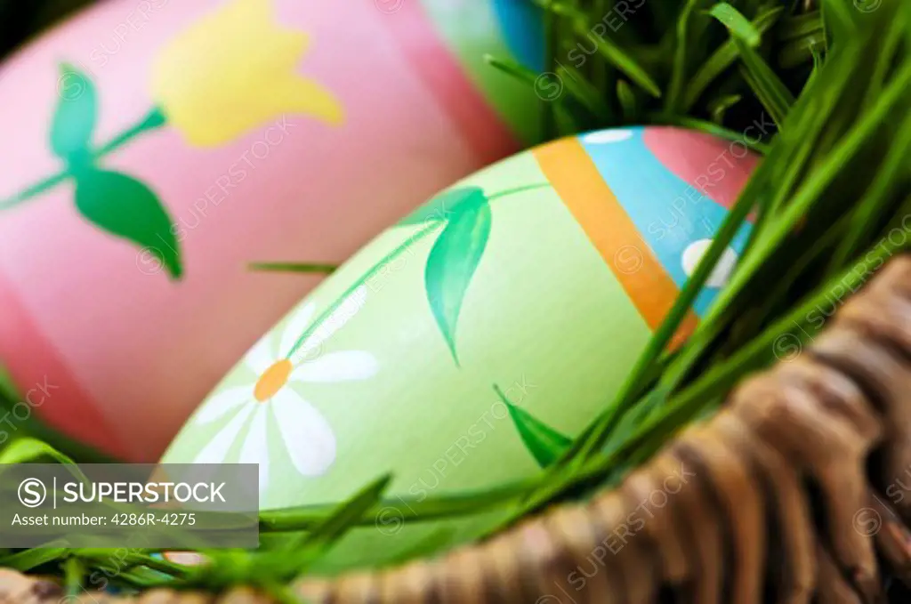 Easter eggs arrangement with green grass in a basket